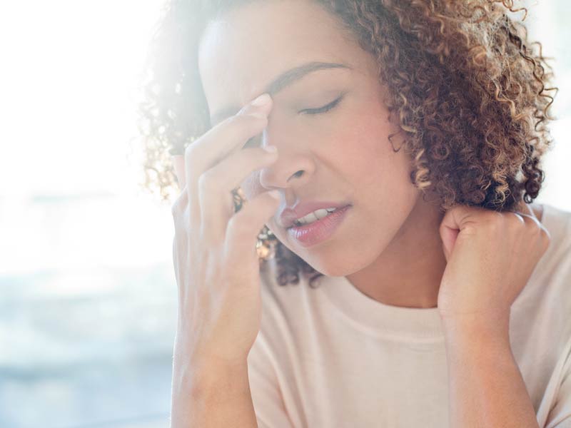 Woman in pain due to migraine